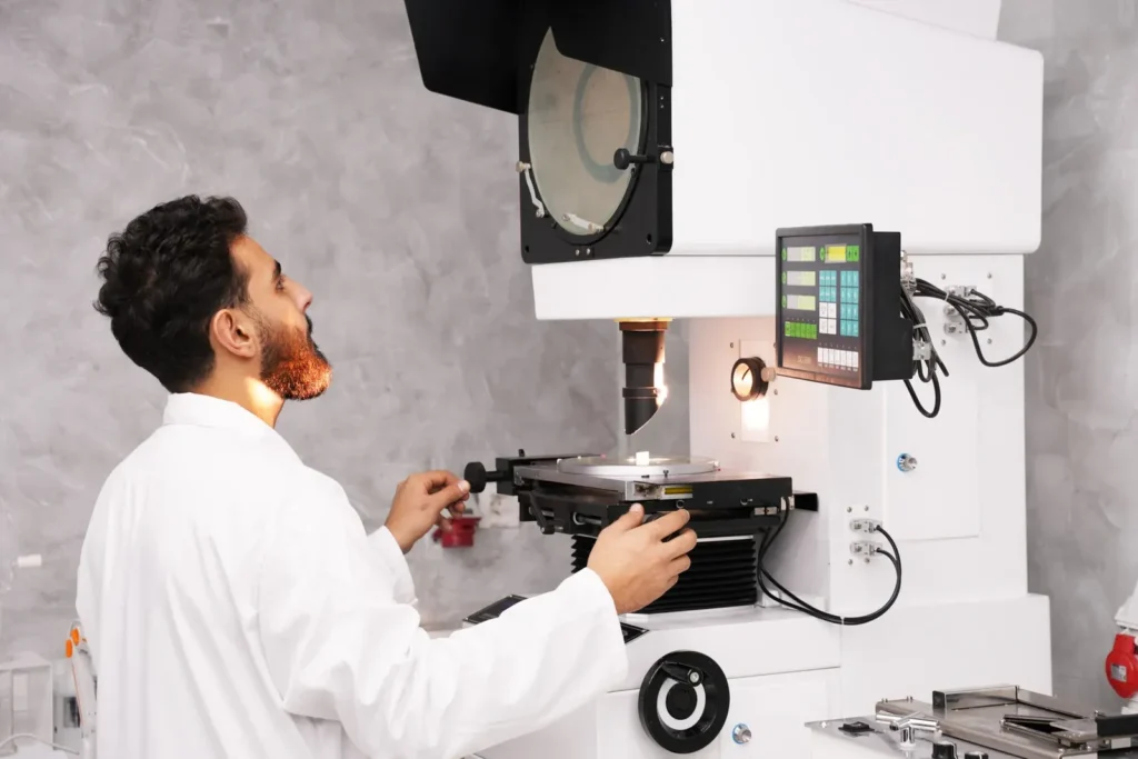 Laboratory technician operating testing equipment at Astro Cables.