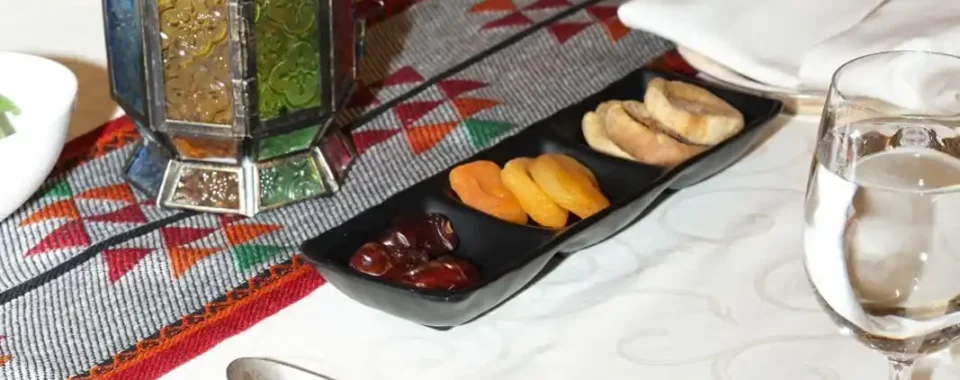 Astro Cables' Ramadan iftar event table setting with company branding.