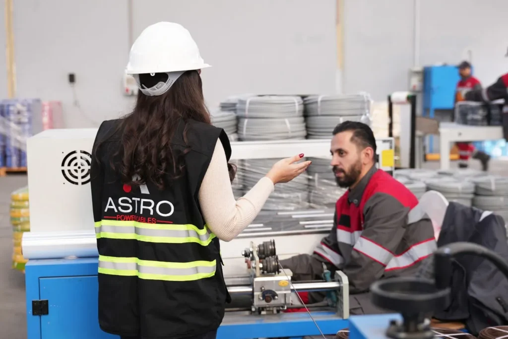 Astro Cables employees collaborating in the factory.