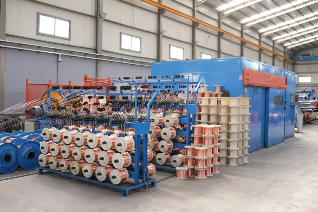 Wire manufacturing process with spools and machinery at Astro Cables.