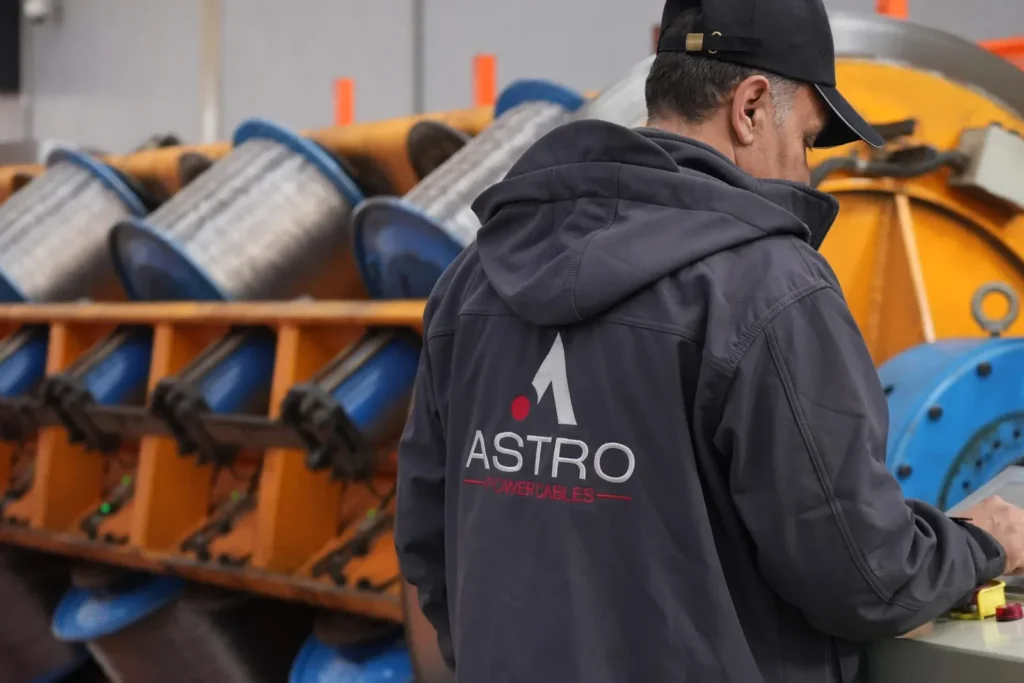 Astro Cables worker operating machinery in the production facility.