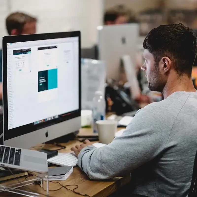 Employee working at Astro Cables office on a computer.