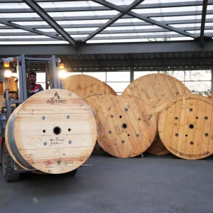 Forklift moving Astro Cables' large cable reels in the warehouse.