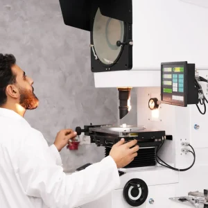 Laboratory technician operating testing equipment at Astro Cables.